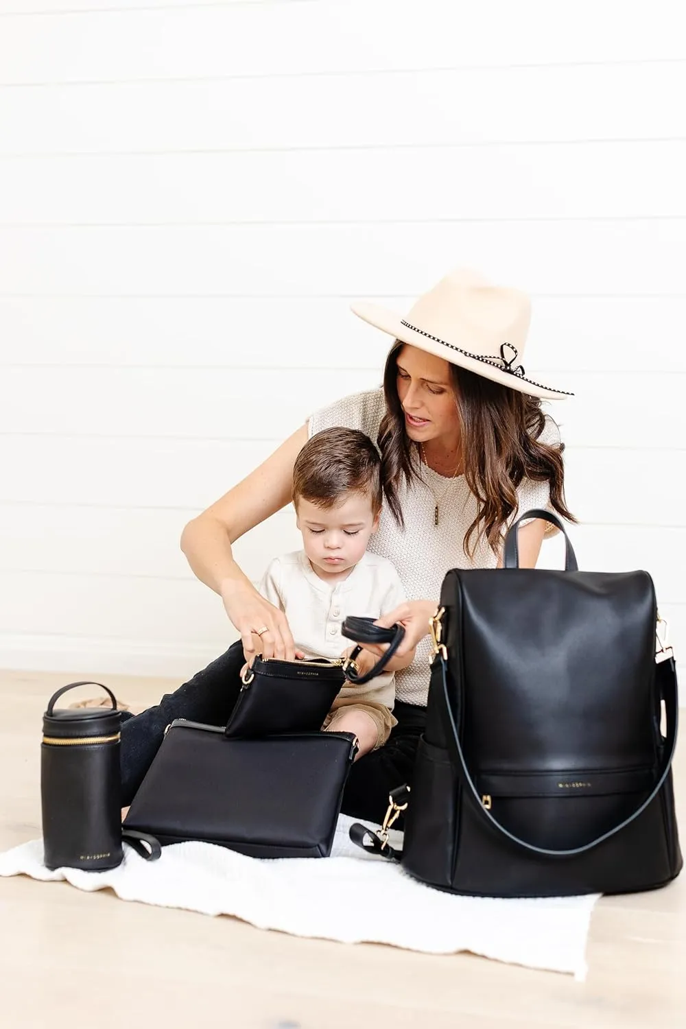 Leather Diaper Bag Backpack with USB Charging port, Changing Pad, Stroller Straps, and Bottle Holder (Black Mia)